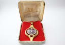 Oris pendant watch displayed open in its original cream-coloured presentation box with gold lettering.