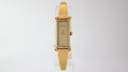 Front view of the gold tone Gucci 1500L watch with champagne rectangular dial.