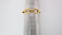 The gold tone integrated bracelet of the Gucci 1500L watch measured on a ring sizer, indicating an internal circumference of 155mm.