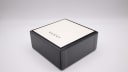 The closed original black Gucci box with the brand logo on the lid.