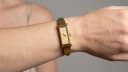 Angled view of the Gucci 1500L watch worn on a human wrist, showing its elegant profile.