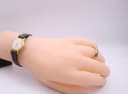 The Slava watch worn on a mannequin hand, providing a visual scale of its petite size.