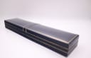 A closed view of the blue presentation box with gold detailing.