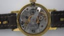 Close-up of the manual wind movement of the Slava watch, showing gears, jewels, and serial number '11919'.