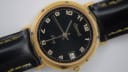 Angled front view of the Ingersoll gold-tone quartz watch with a black dial and Arabic numerals.