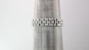 The Tissot L730K stainless steel bracelet displayed on a wrist sizing cone, showing a wrist size of approximately 16cm.