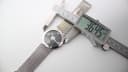 Digital caliper measuring the watch case diameter at 36.45mm.