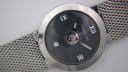 Close-up of the black dial, showing Roman numerals, date window, and central seconds disc.
