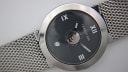 Another close-up of the textured black dial and white hands.