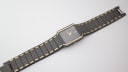 Overhead view of the Seiko watch and its integrated two-tone bracelet laid flat on a white surface.