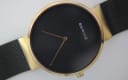 Close-up of the minimalist black dial with gold-tone hands and "BERING" logo at 12 o'clock.