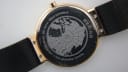 Close-up of the case back showing 'STAINLESS STEEL 14539-166 WATER RESISTANT 5 ATM SAPPHIRE CRYSTAL' engraving and a world map design.