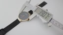 Digital caliper measuring the case diameter of the Bering watch at 39.07mm, with the mesh strap laid out.