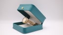 The Seiko watch displayed in a green presentation box.
