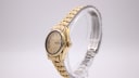 Angled side view of the vintage gold-tone Seiko automatic watch, showing the tonneau case and bracelet.