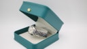 Eterna Concept 80 watch resting inside a generic green presentation box.