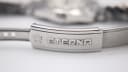 Close-up of the signed Eterna fold-over clasp on the steel bracelet.