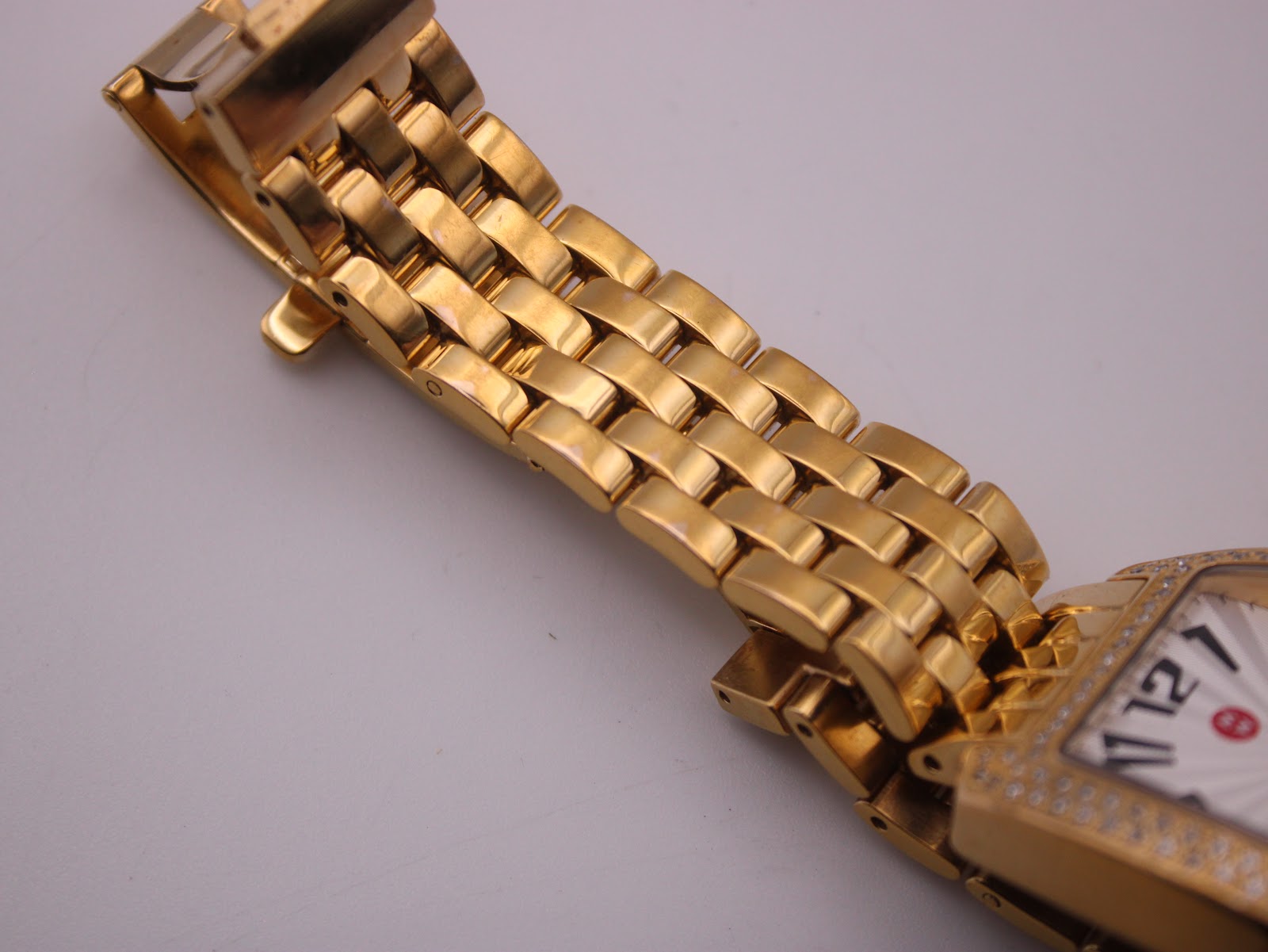 Digital caliper measuring the case diameter of the gold-tone Michele watch, displaying 29.37mm.