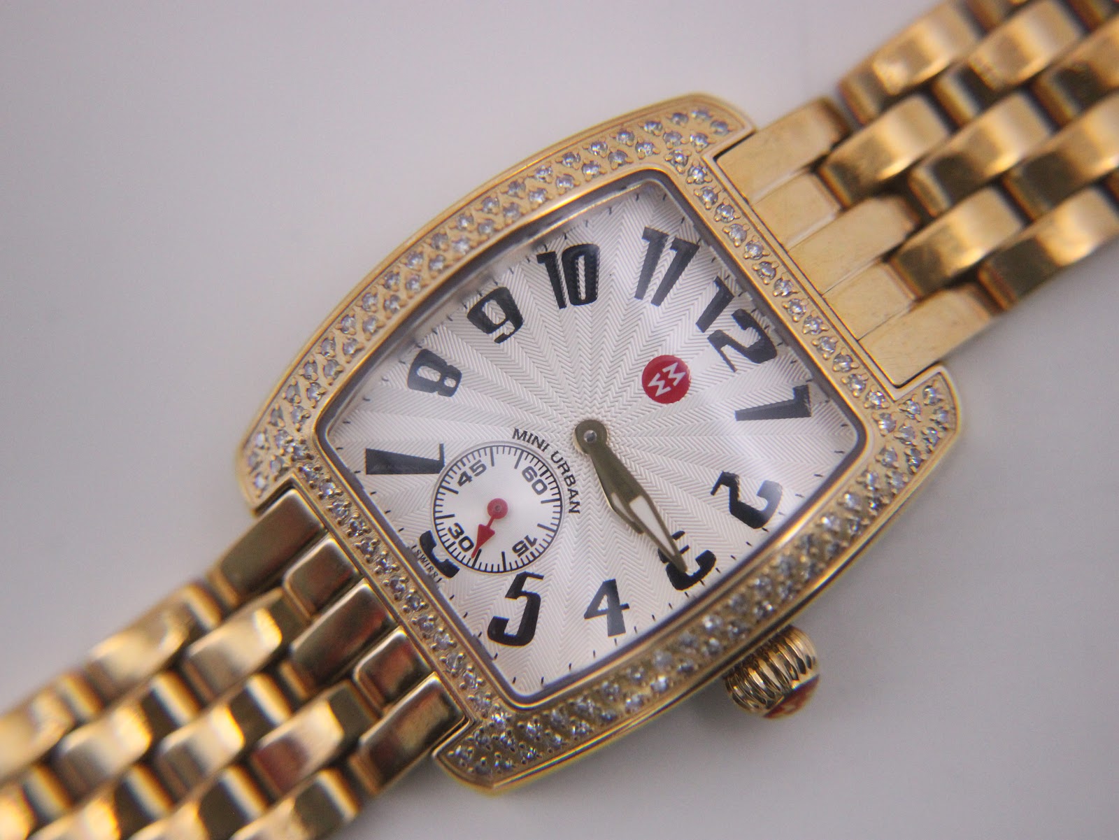 Rear view of the Michele watch case back, showing engravings for stainless steel, sapphire crystal, water resistance, model, and serial number.