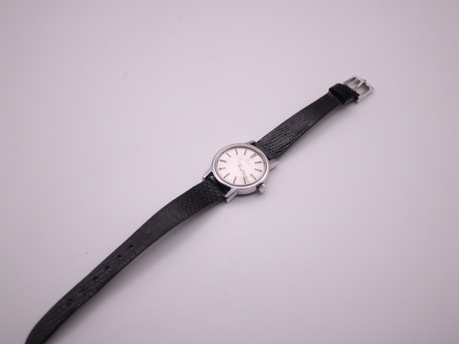Rear view of the Eterna watch, showing the plain case back and "Genuine Lizard" text on the strap.