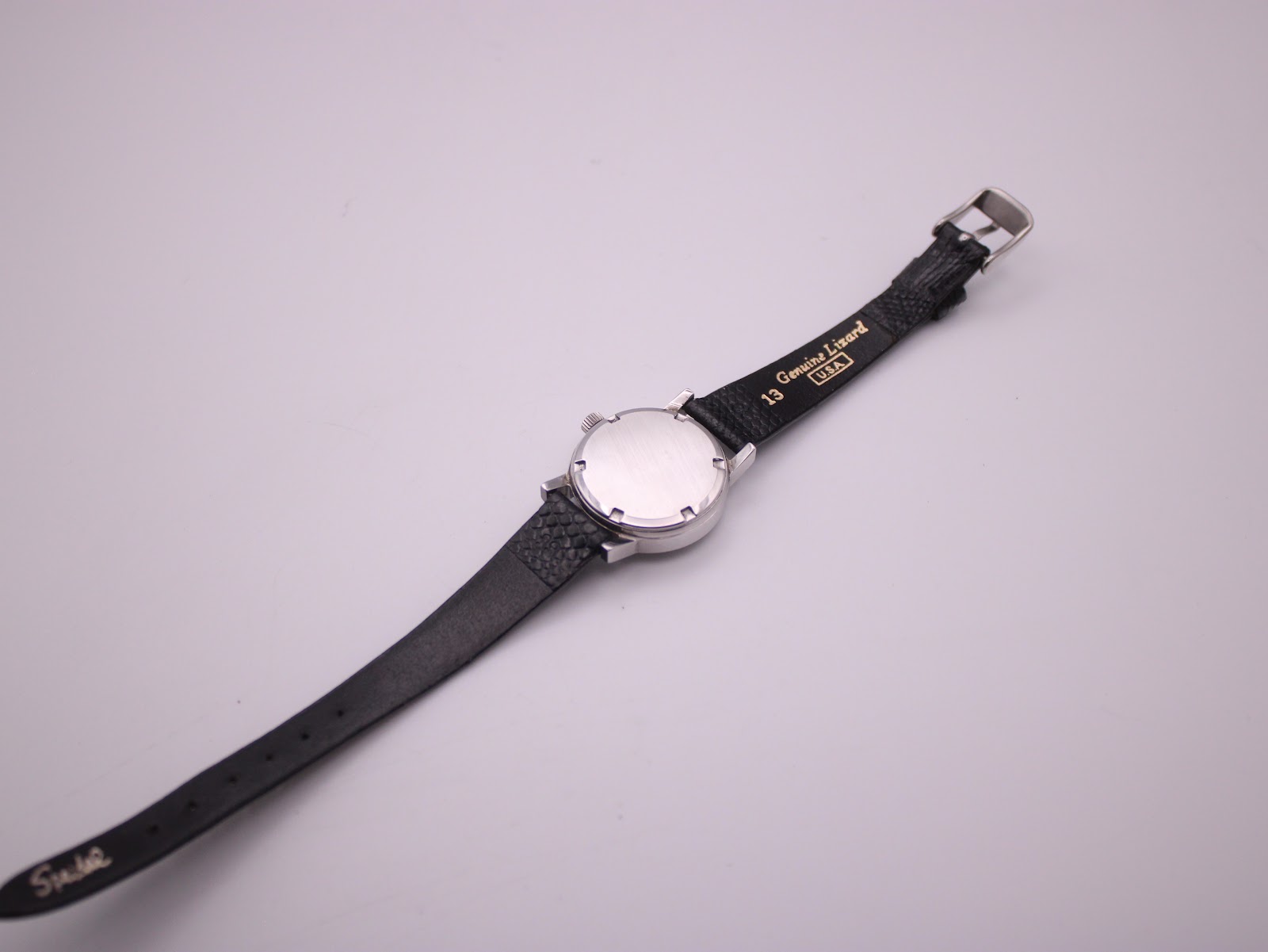 Close-up of the Eterna watch dial, showing the applied logo, text, and baton indices.