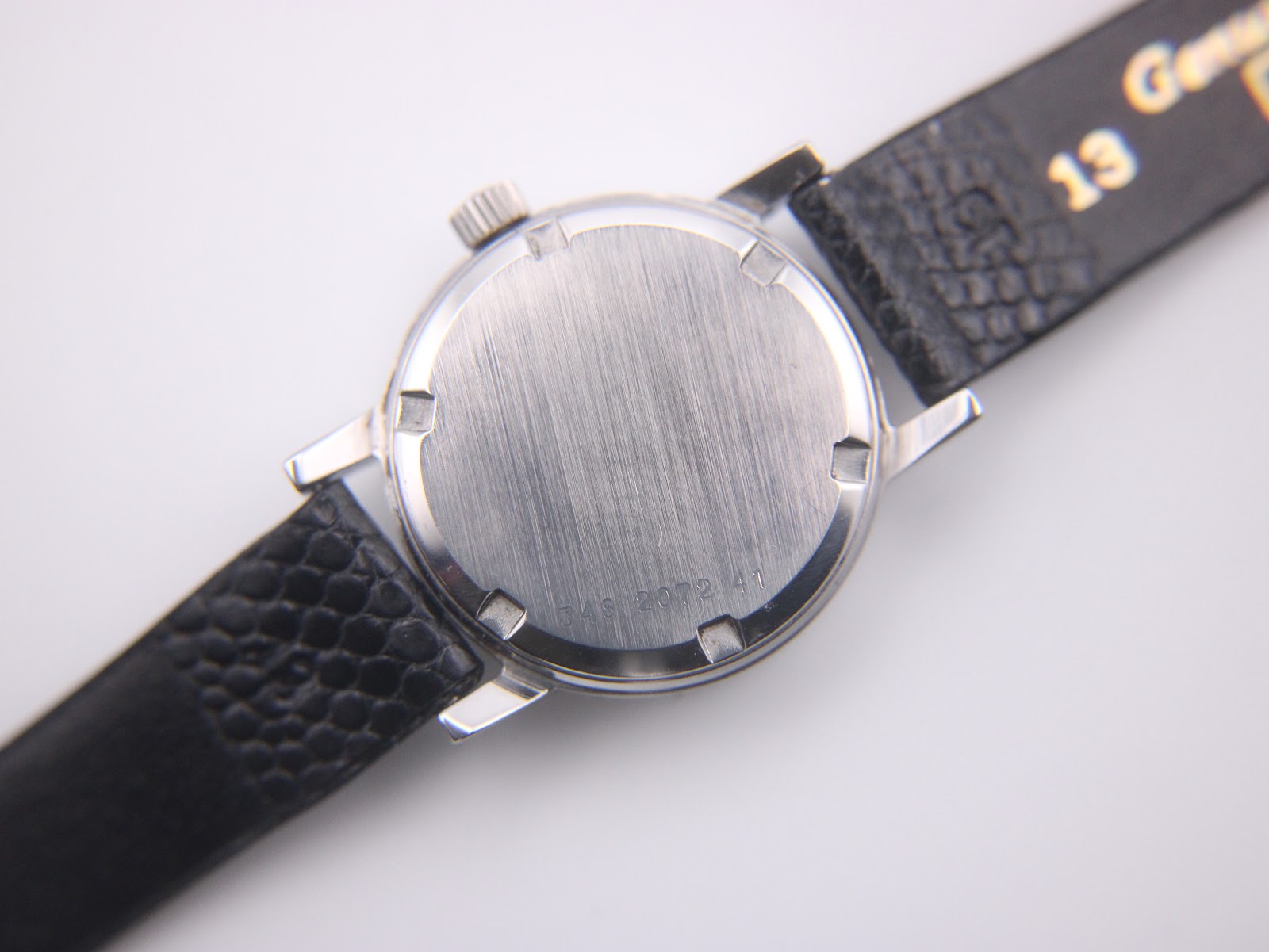 Open movement view of the Eterna watch, showing the 17 jewels and "ETERNA WATCH CO SWISS" engraving.