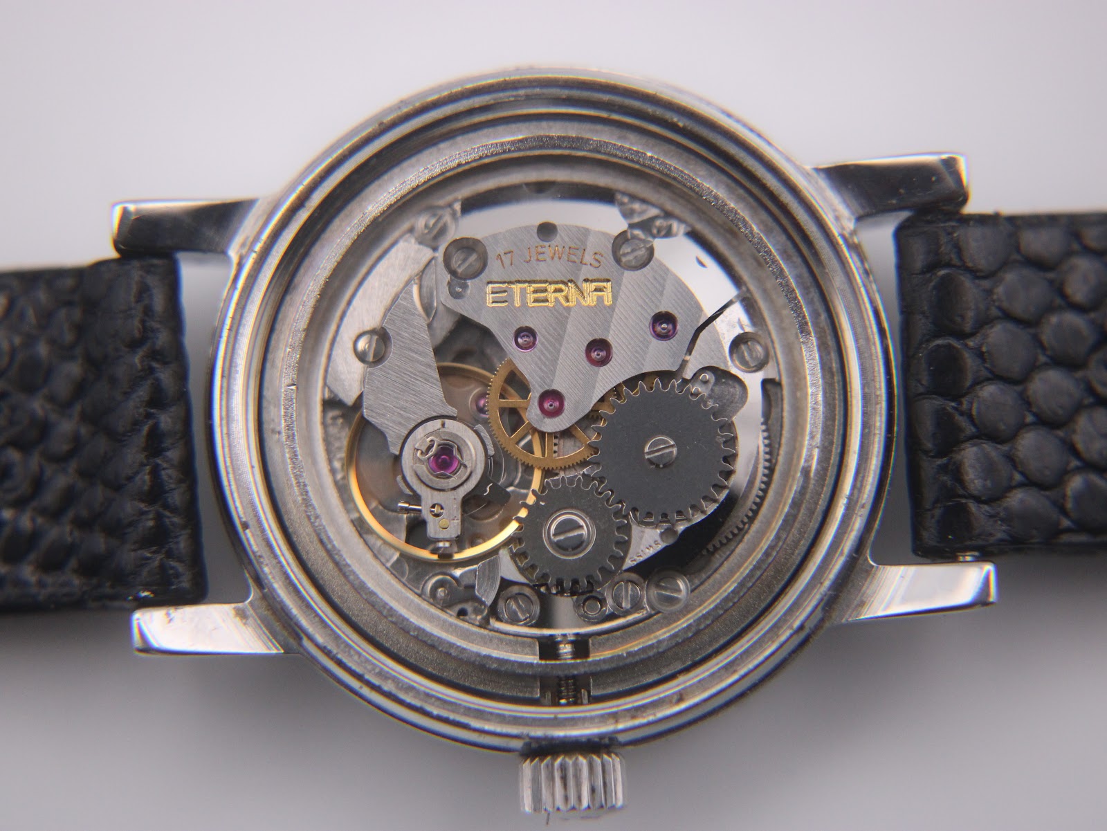Interior of the case back, confirming "ETERNA WATCH CO SWISS" and "STAINLESS STEEL".