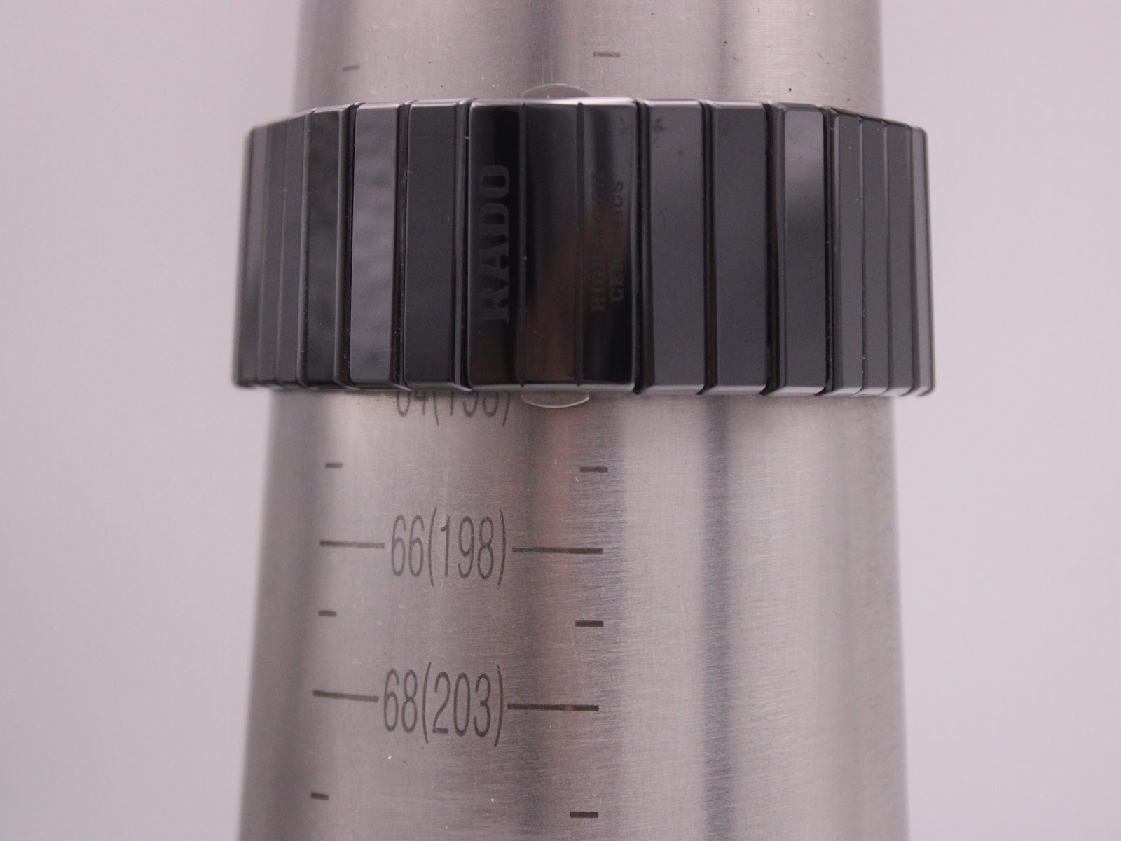 The Rado Diastar watch on a metal conical display stand, showing the fit of the ceramic bracelet.