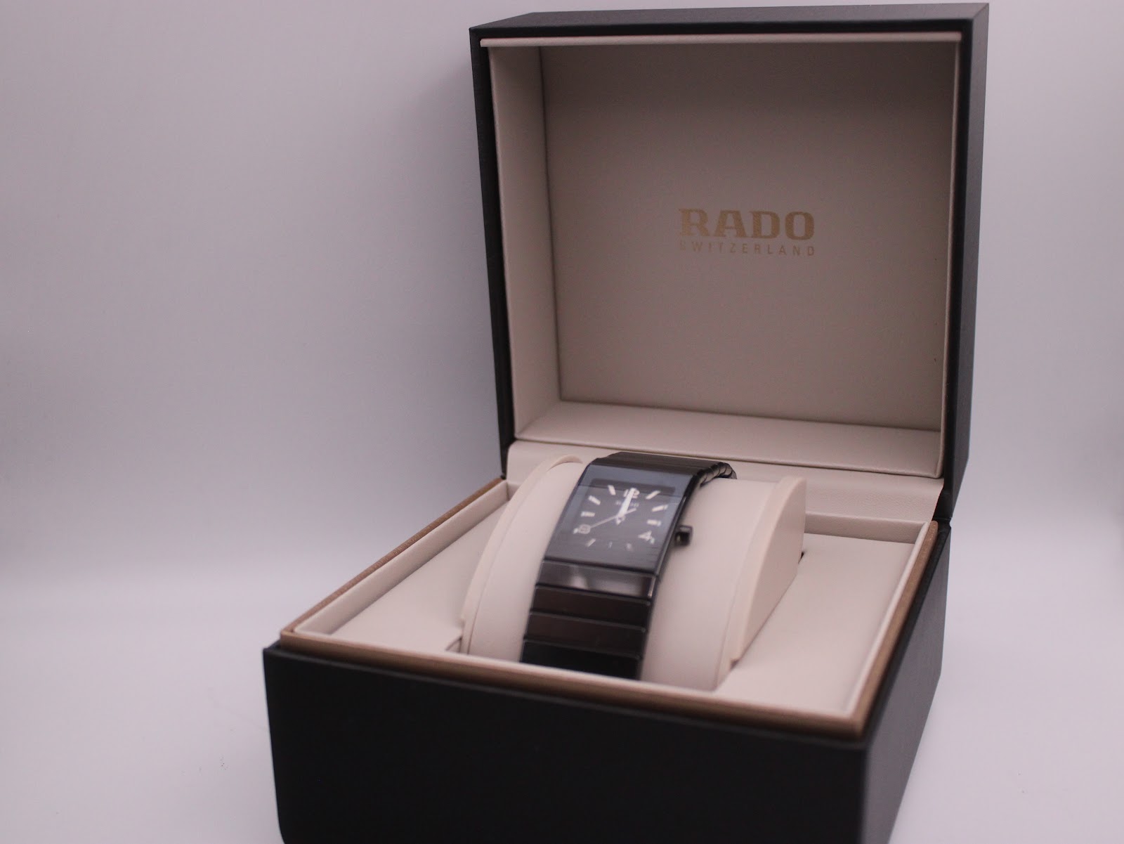 The Rado Diastar watch presented within its original black RADO branded presentation box with a cream interior.