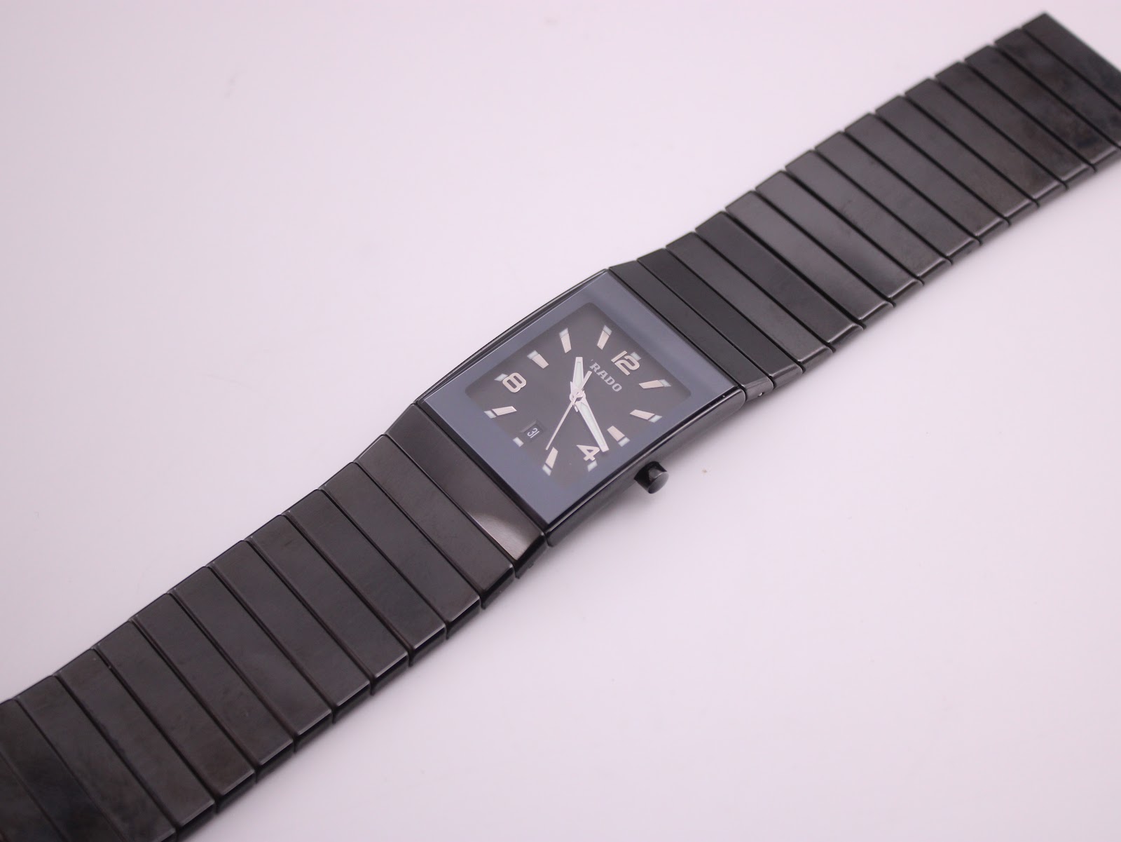 Top-down view of the Rado Diastar watch with its black ceramic case and bracelet laid flat, showing the full length.
