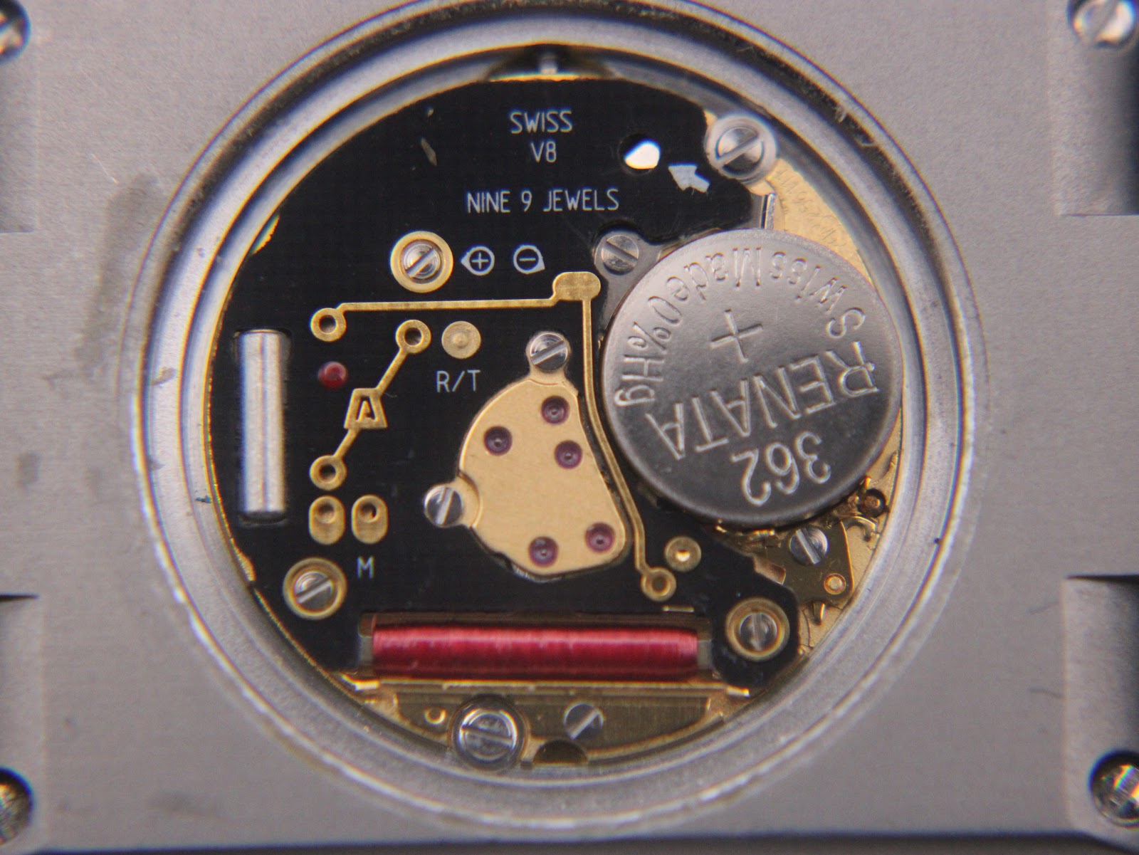 Macro view of the Swiss quartz movement inside the Rado Diastar, showing the battery (Renata 362) and "SWISS V8 NINE 9 JEWELS" engraving.
