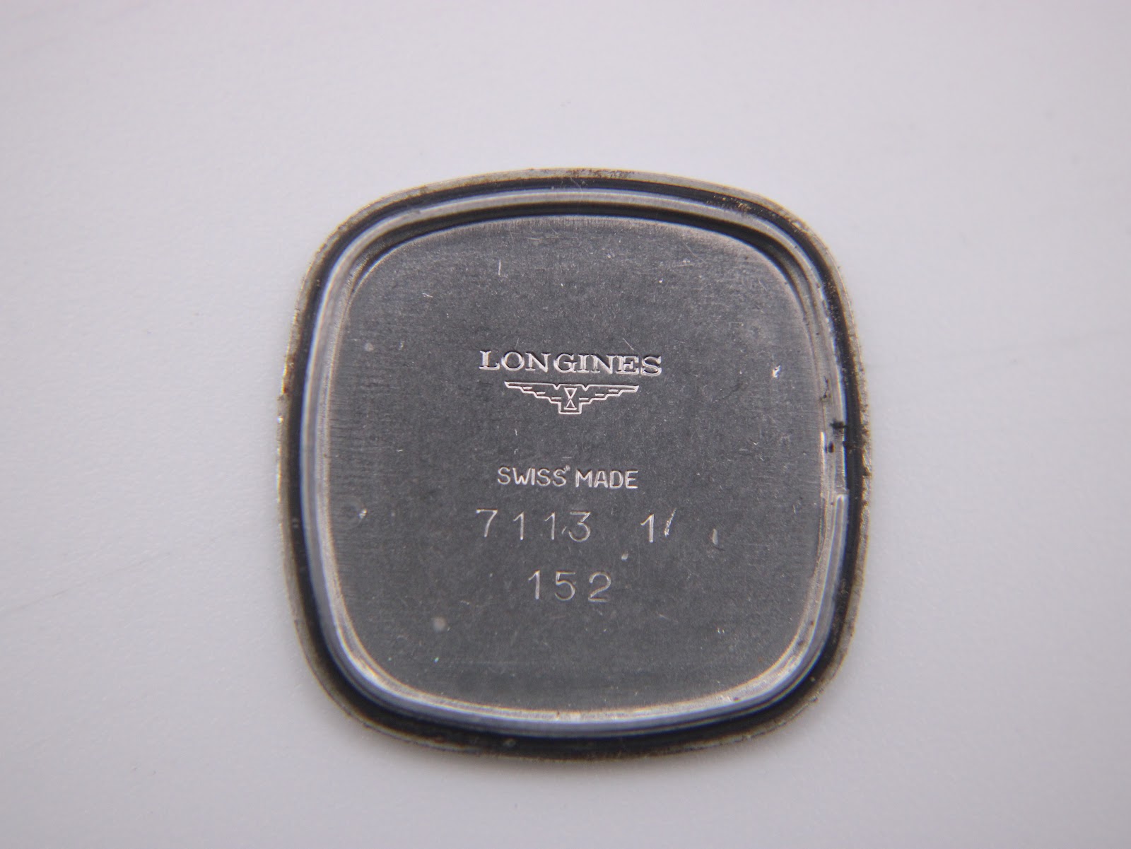 Inner case back of the Longines Presence watch, displaying 'Longines Swiss Made' and model numbers 7113 1/ 152.