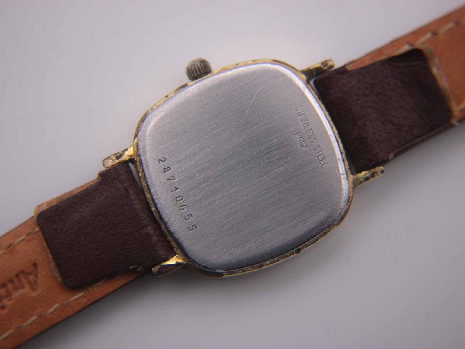 Close-up of the Longines watch stainless steel case back with serial number 24710655 and 'Stainless Steel Back' engraving.