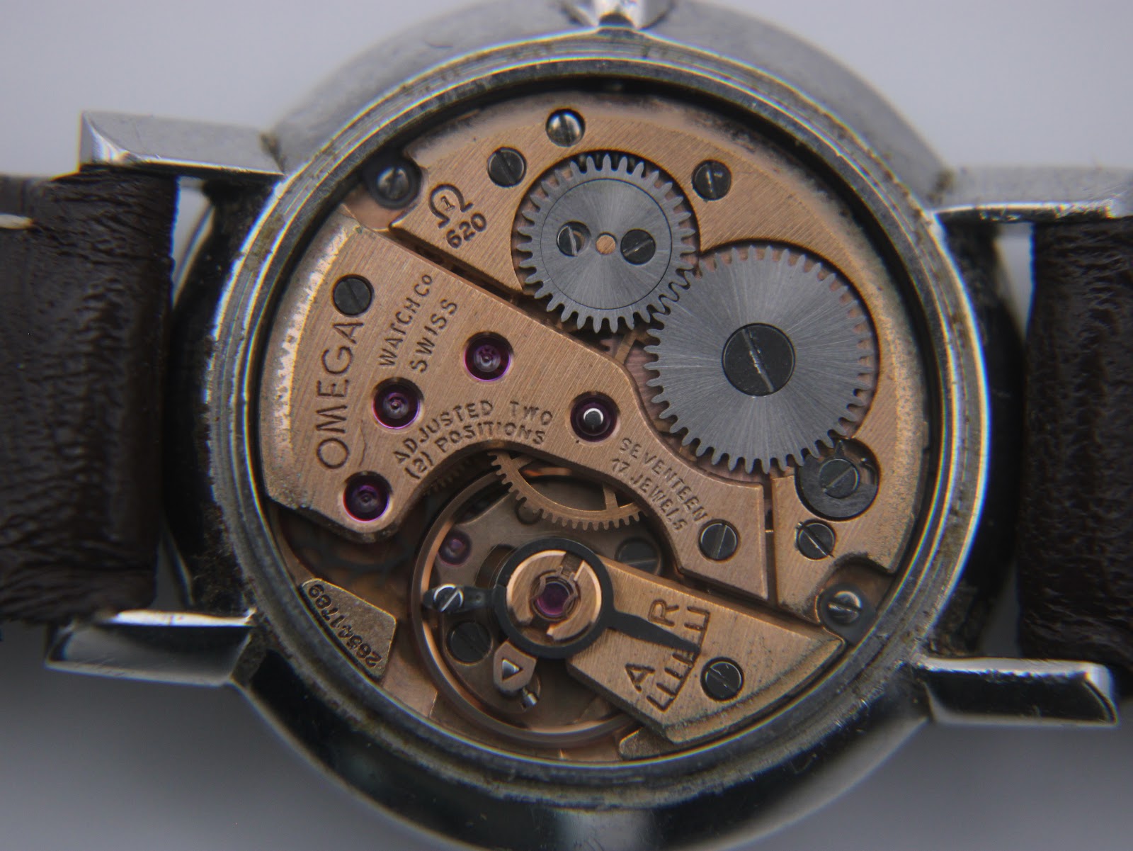 Macro close-up of the Omega Calibre 620 manual wind movement with 17 jewels and serial number 26831789 visible.