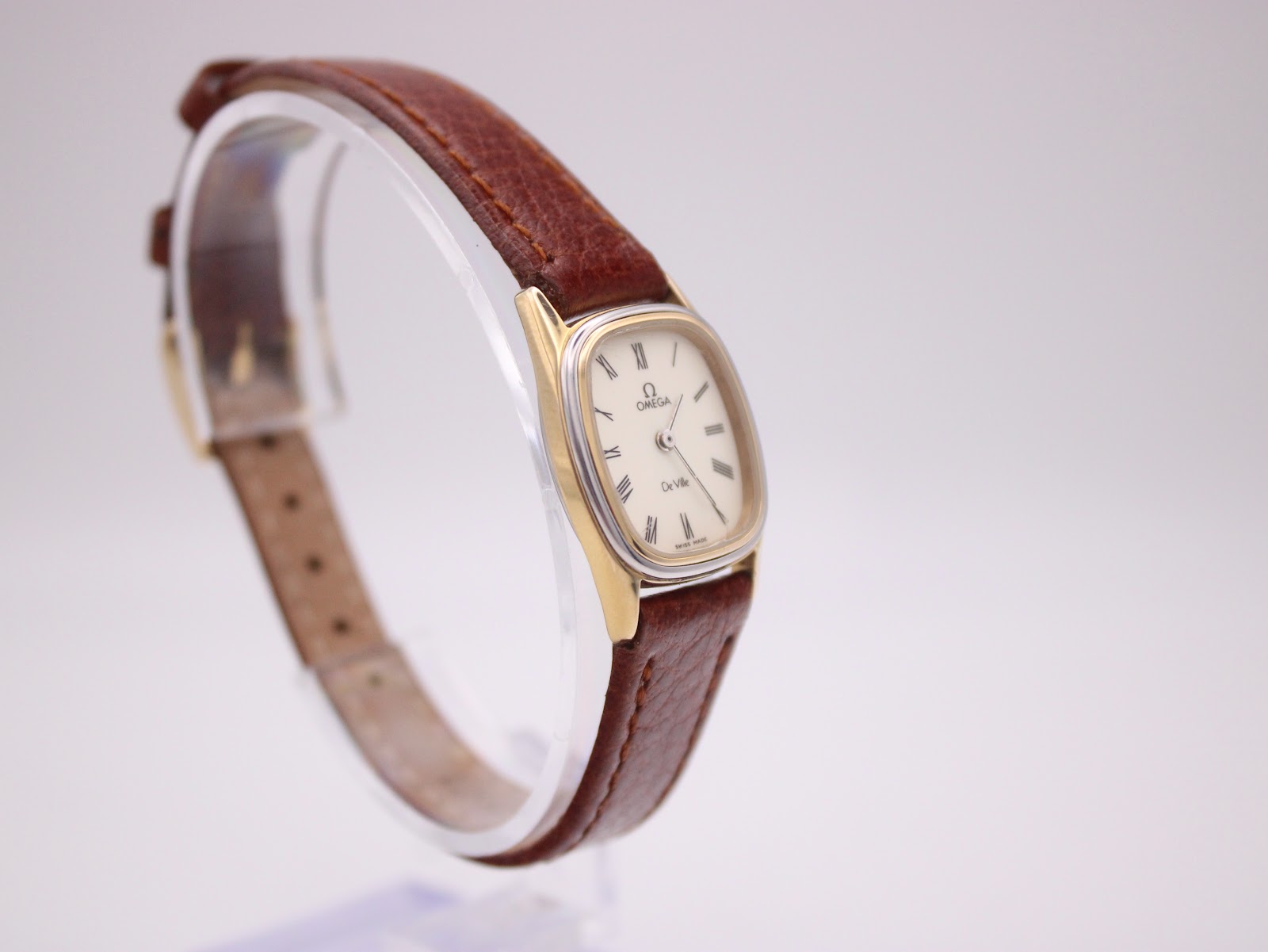 Another angled view of the Omega De Ville, highlighting the watch's profile and strap texture.
