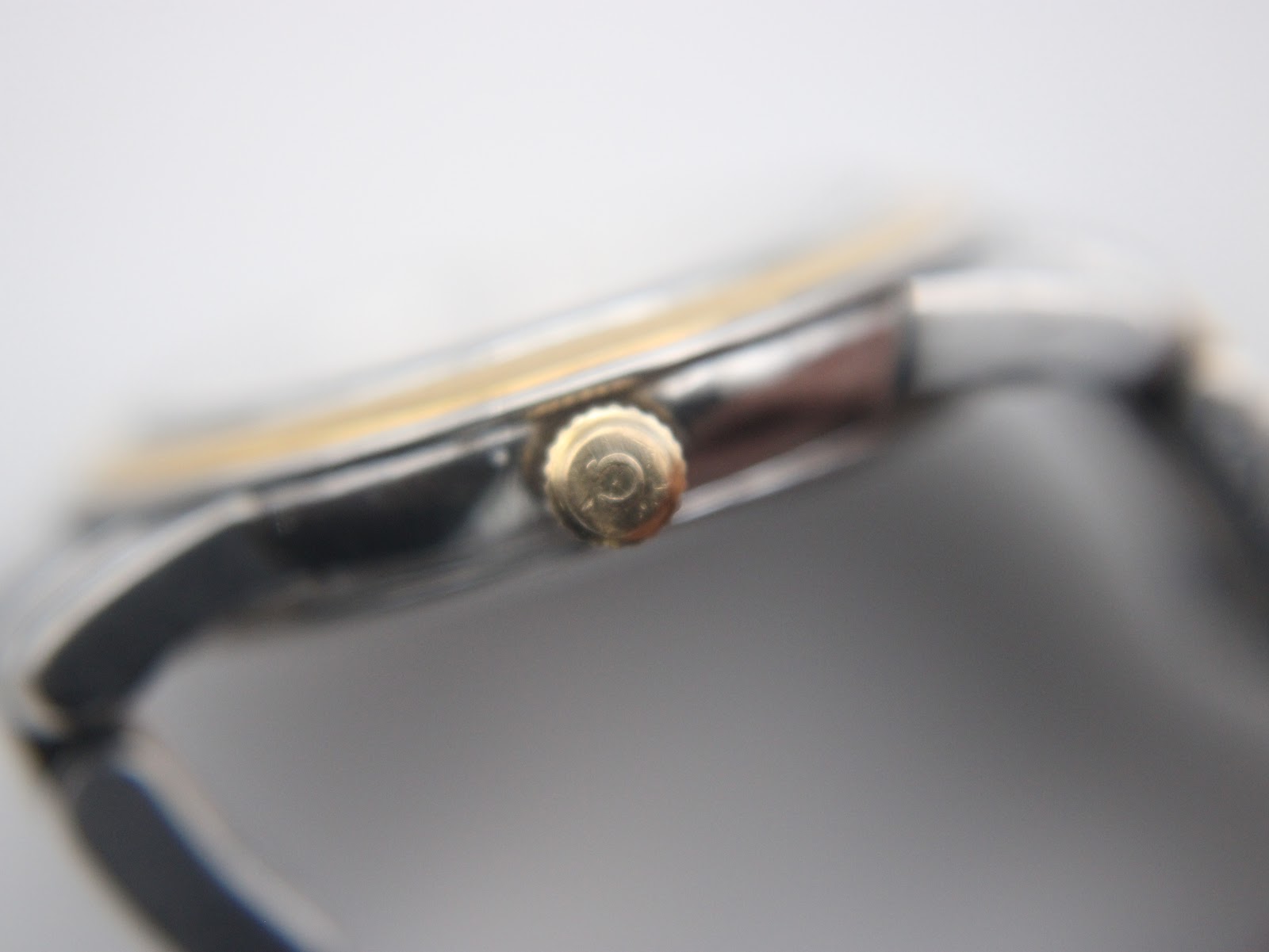 Close-up of the Omega crown, clearly showing the embossed Omega logo.