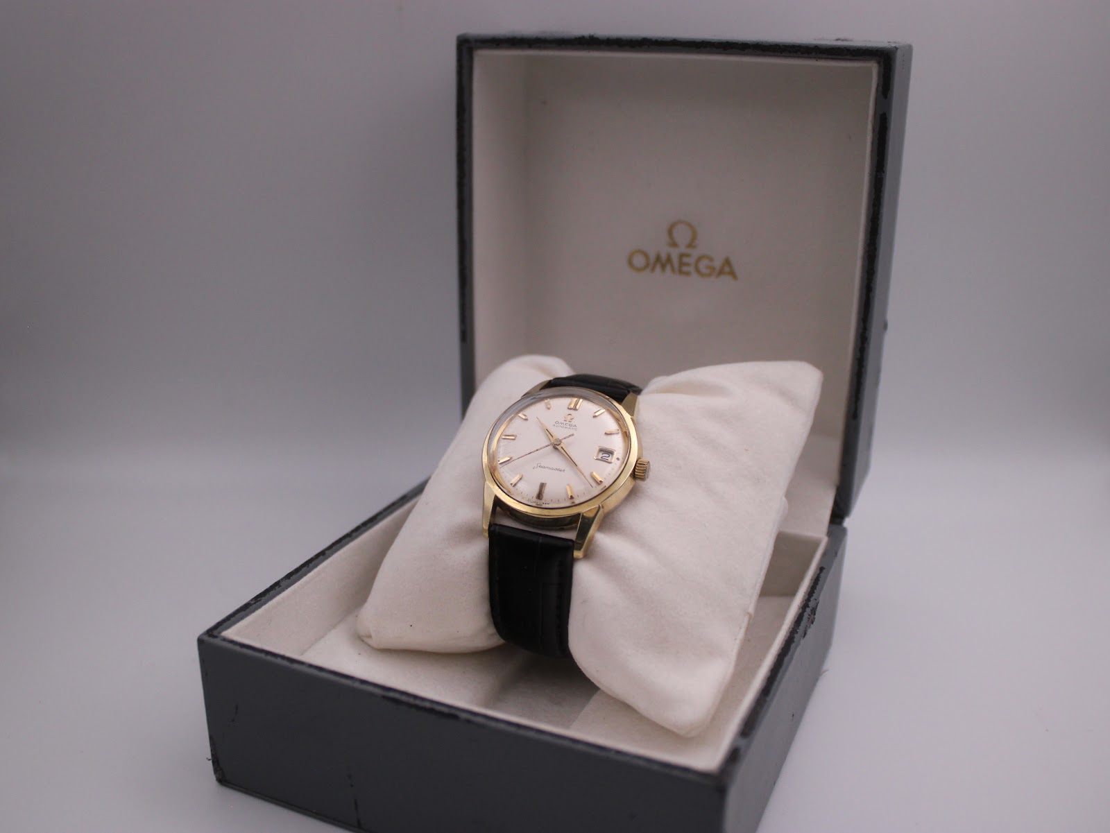 Omega seamaster watch in its original grey omega presentation box with cream cushion.