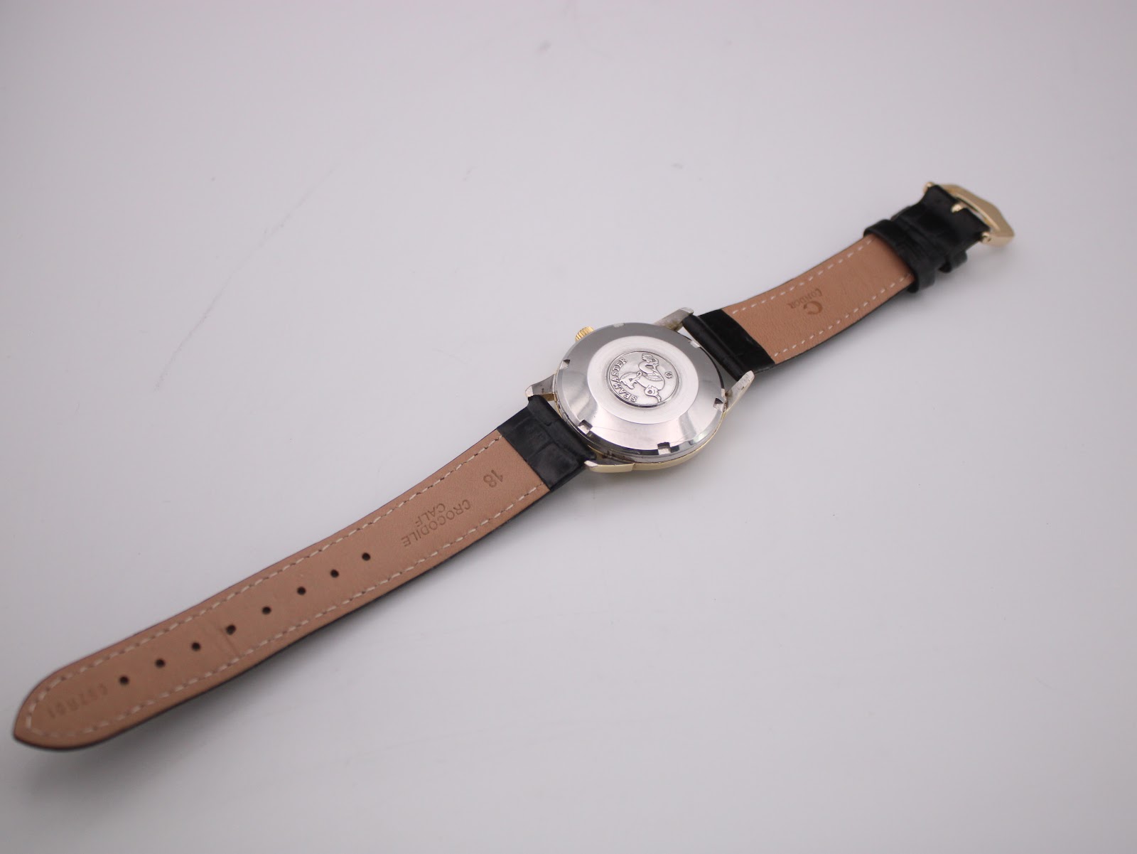 Back view of the omega seamaster watch with the black leather strap, showing '18 CROCODILE' on the strap.