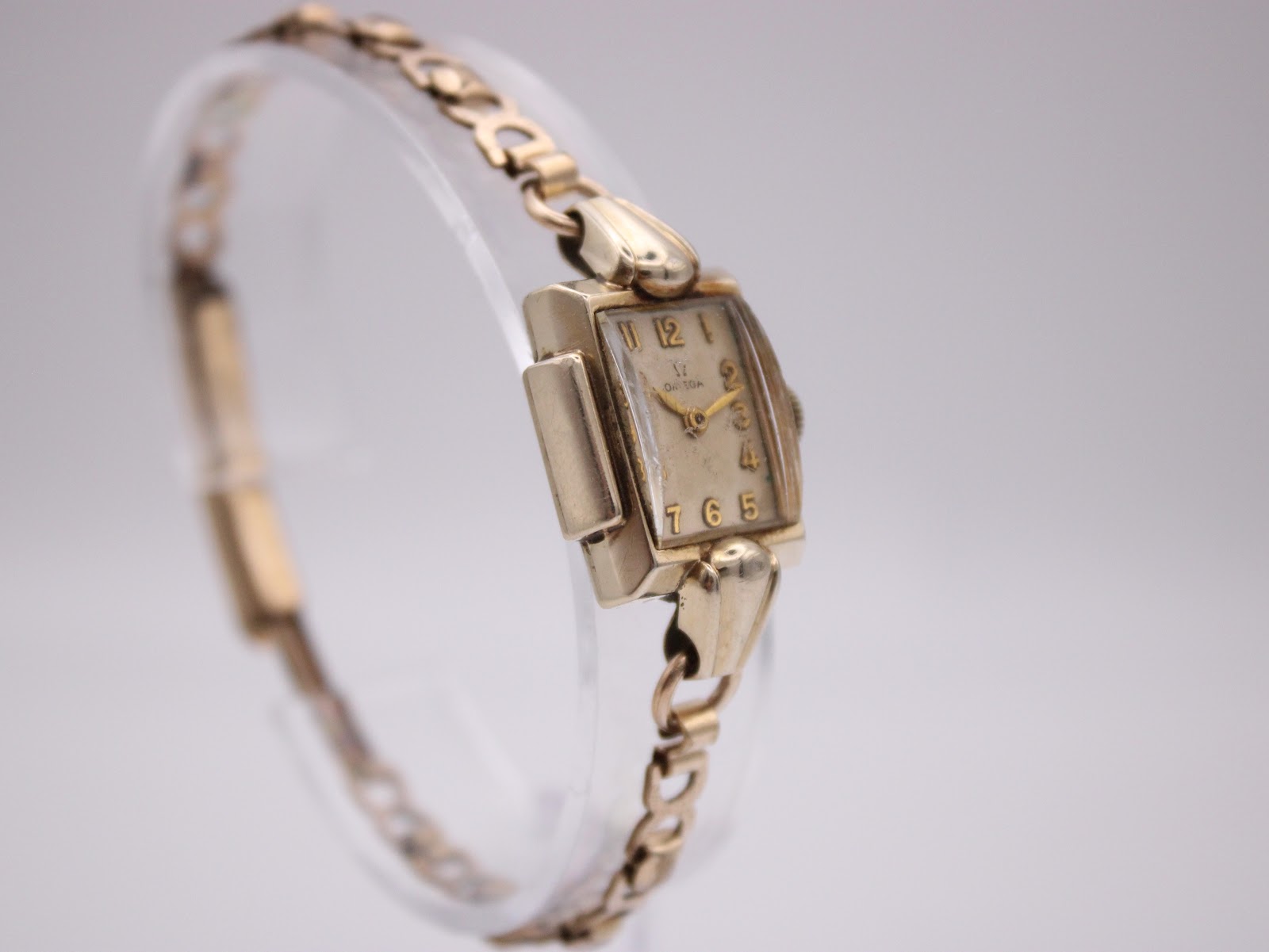 Another angled view of the Omega watch highlighting the case shape and integrated bracelet.