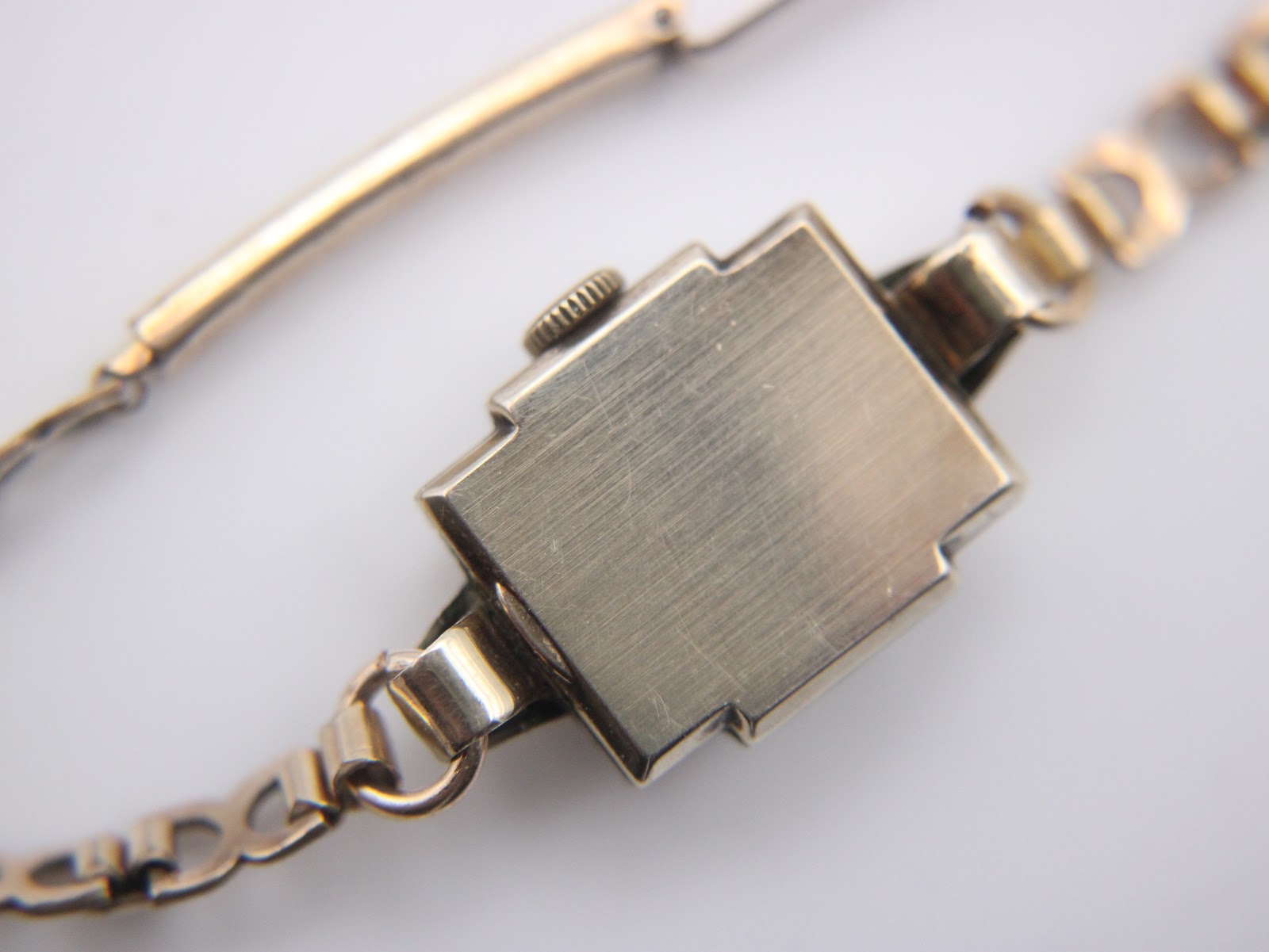 Close-up of the brushed finish case back of the rectangular Omega watch.