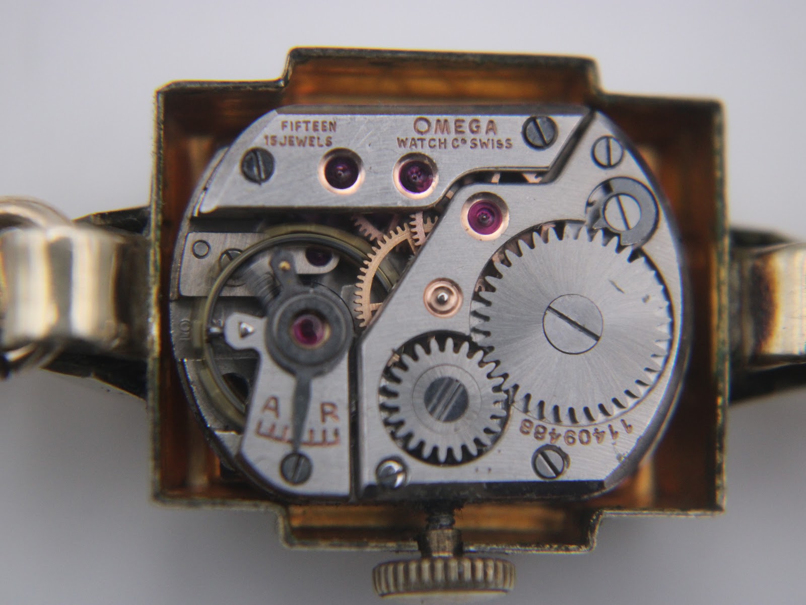 Close-up of the manual wind Omega movement, showing "OMEGA WATCH Co SWISS" and "FIFTEEN 15 JEWELS" and serial number 1140988.