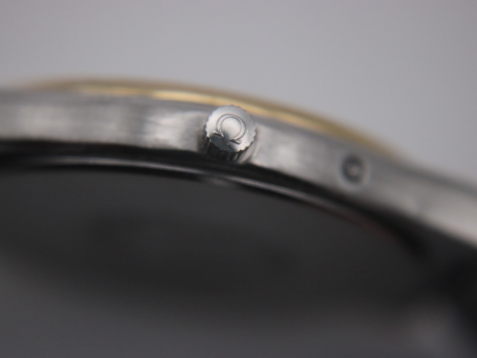 Extreme close-up of the Omega-signed crown.
