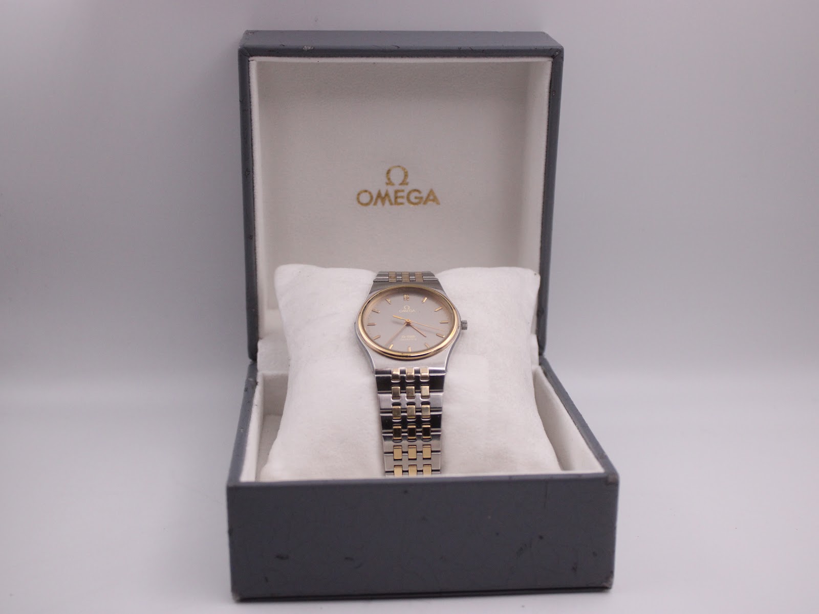 The Omega De Ville watch presented in its original grey Omega presentation box.
