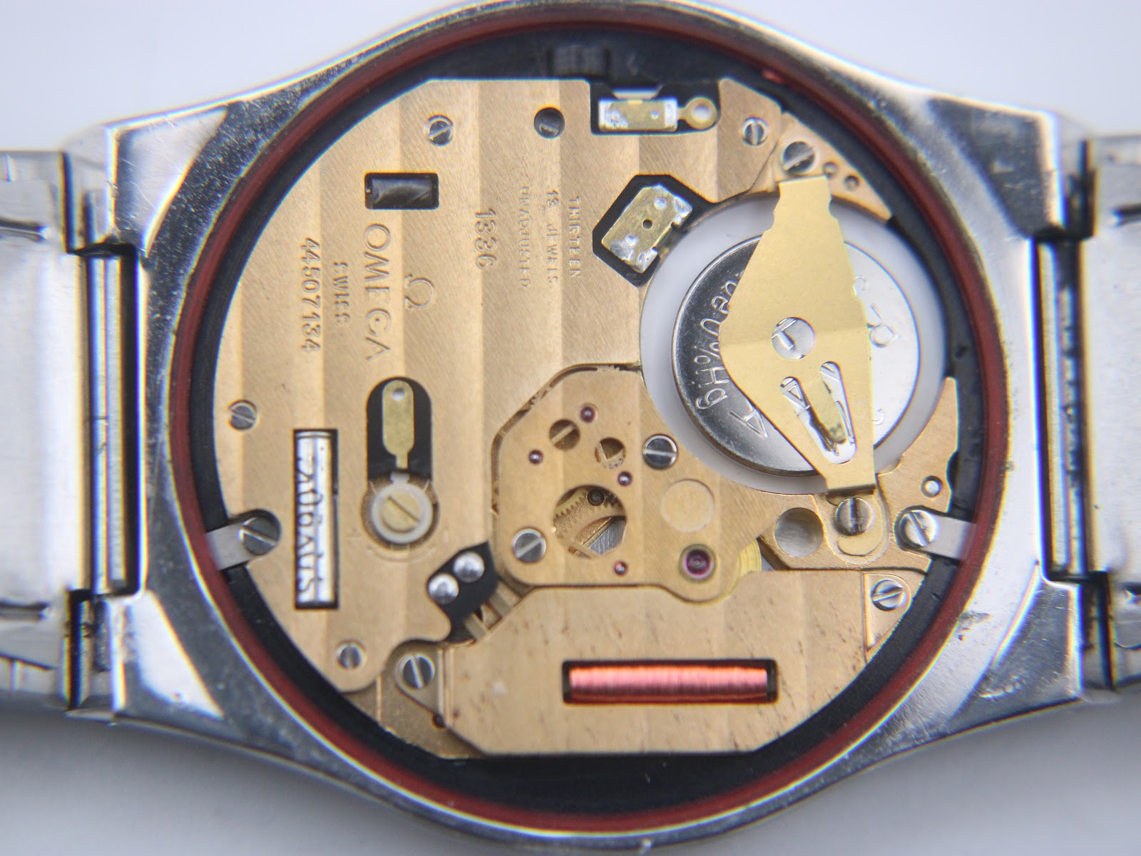 Close-up of the Omega quartz movement inside the watch, showing serial number 4407134 and 'SWISS 1330'.