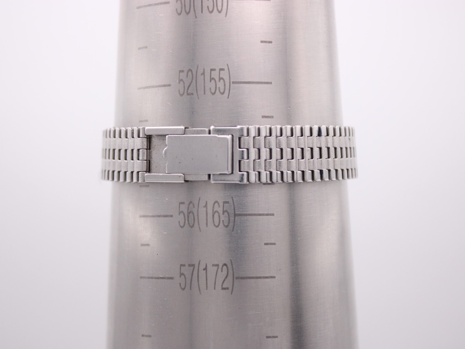 Watch bracelet wrapped around a wrist sizing cone, indicating a maximum wrist circumference of approximately 15.5cm or 55mm.