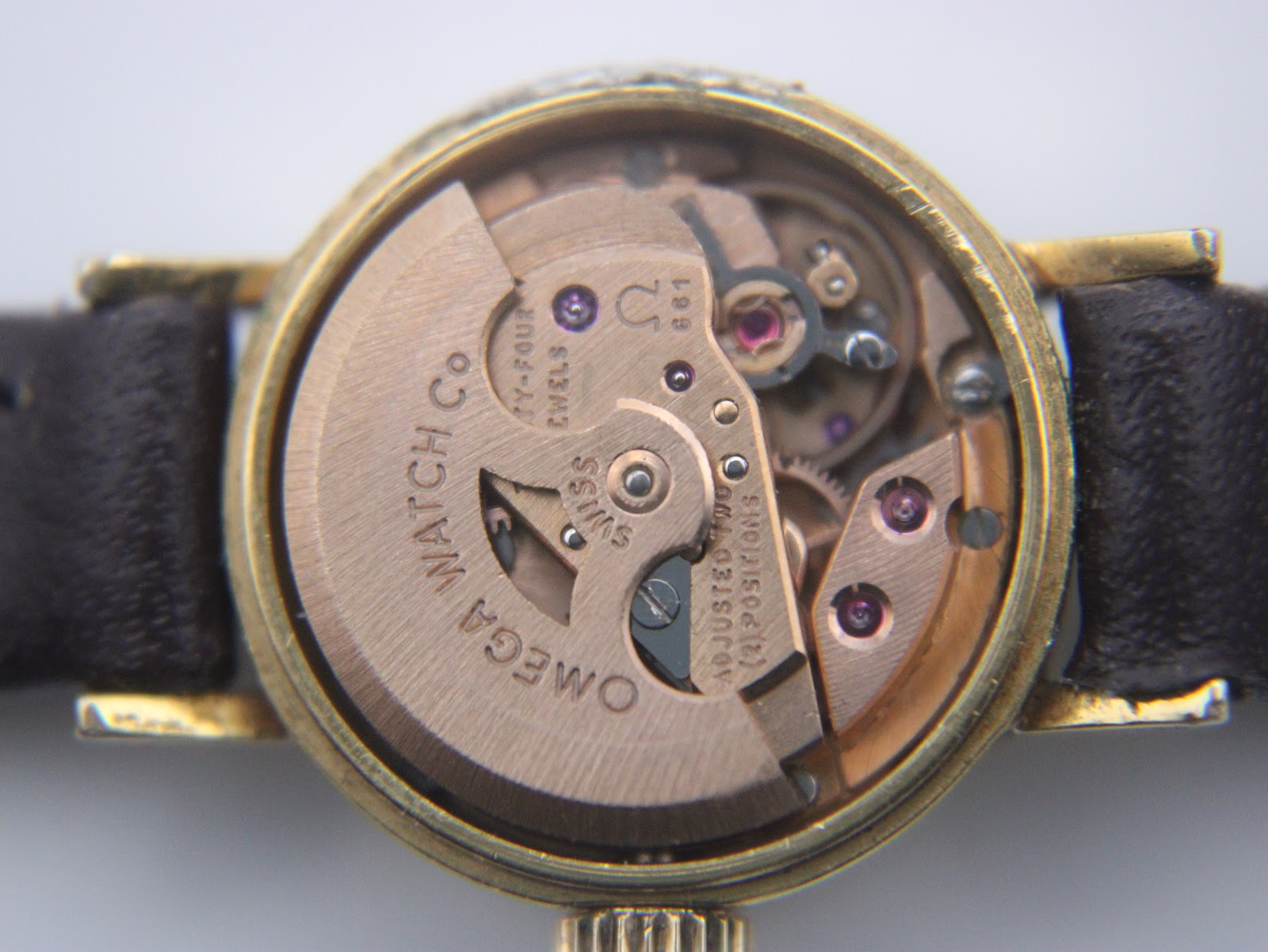 Detailed view of the Omega calibre 661 automatic movement, showing the rotor, jewels, and engravings.