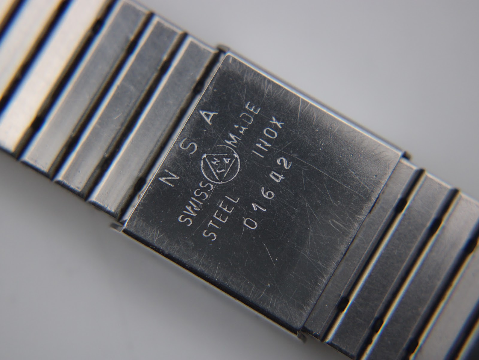 Close-up of the gold-tone folding clasp with 'RADO' engraved.