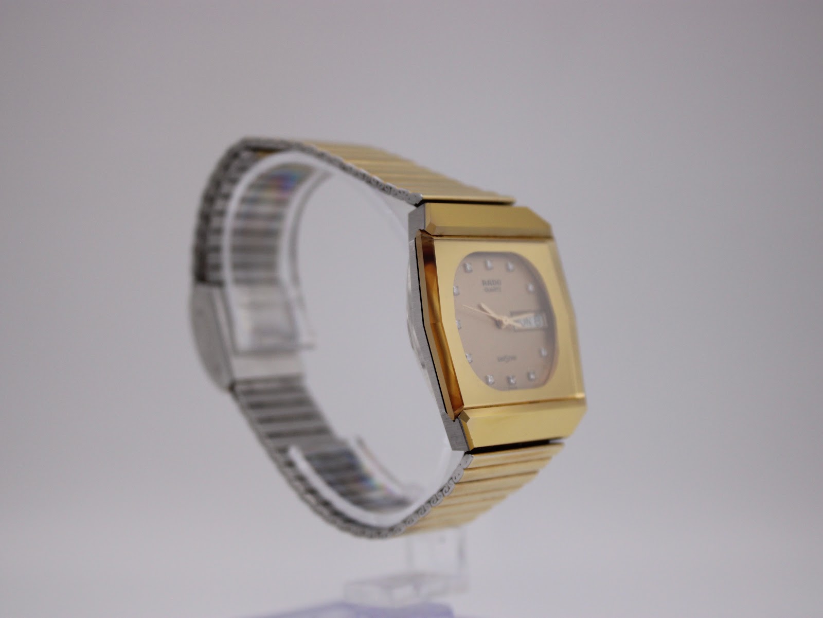 Side angled view of the Rado Diastar on a watch stand, showing the crown.