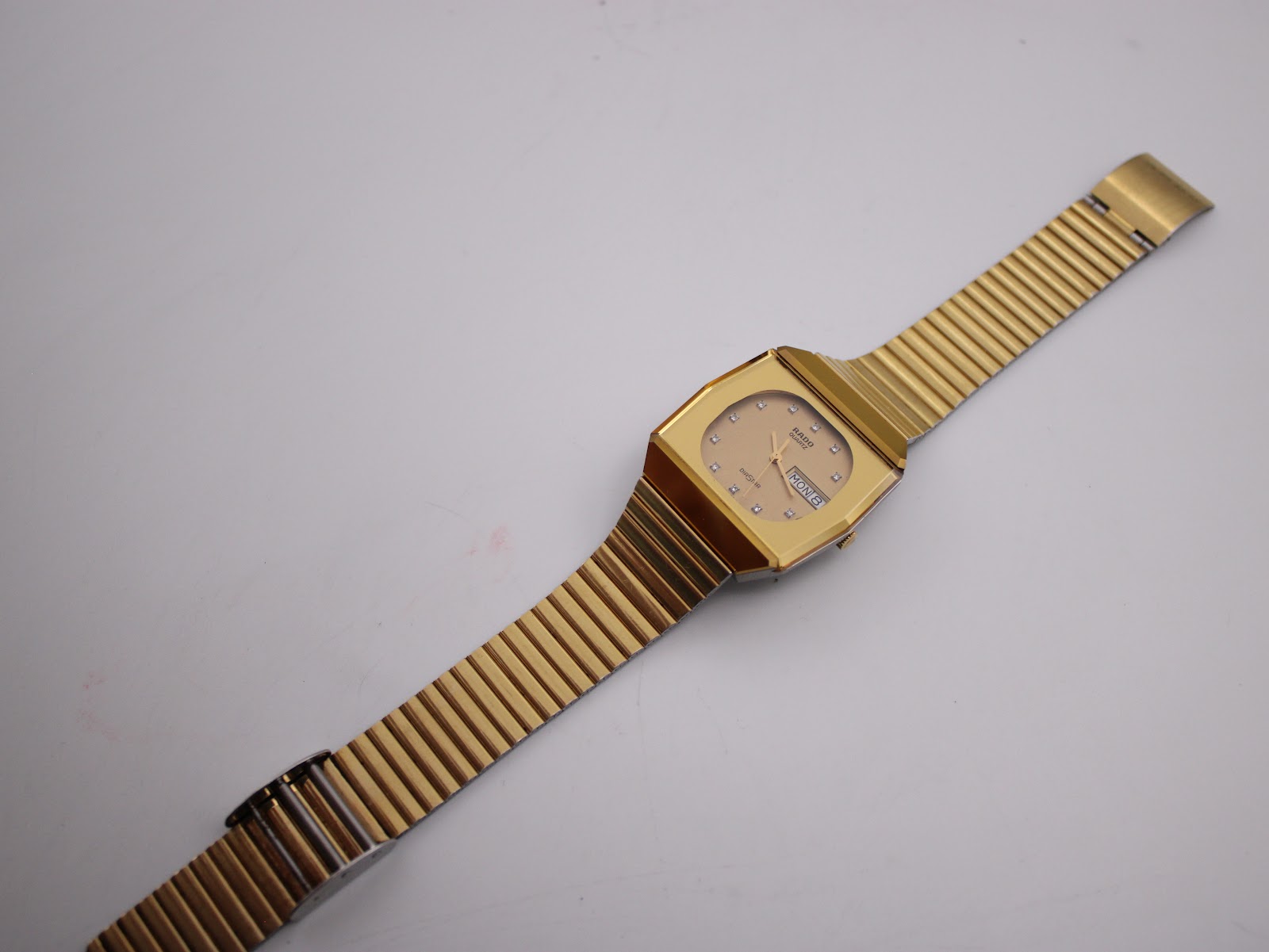 Another side angled view of the Rado Diastar on a stand, showing the two-tone bracelet.