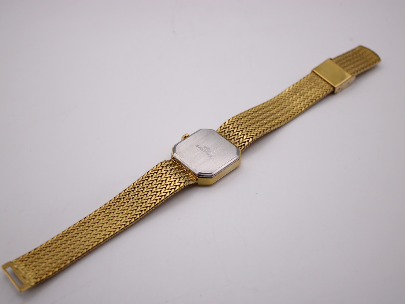 View of the Santima watch from the back, showing the brushed stainless steel case back and extended mesh bracelet.